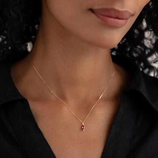 Close-up of woman wearing July Birthstone Pendant 14k Gold - Pink Tourmaline on a delicate gold chain with black top