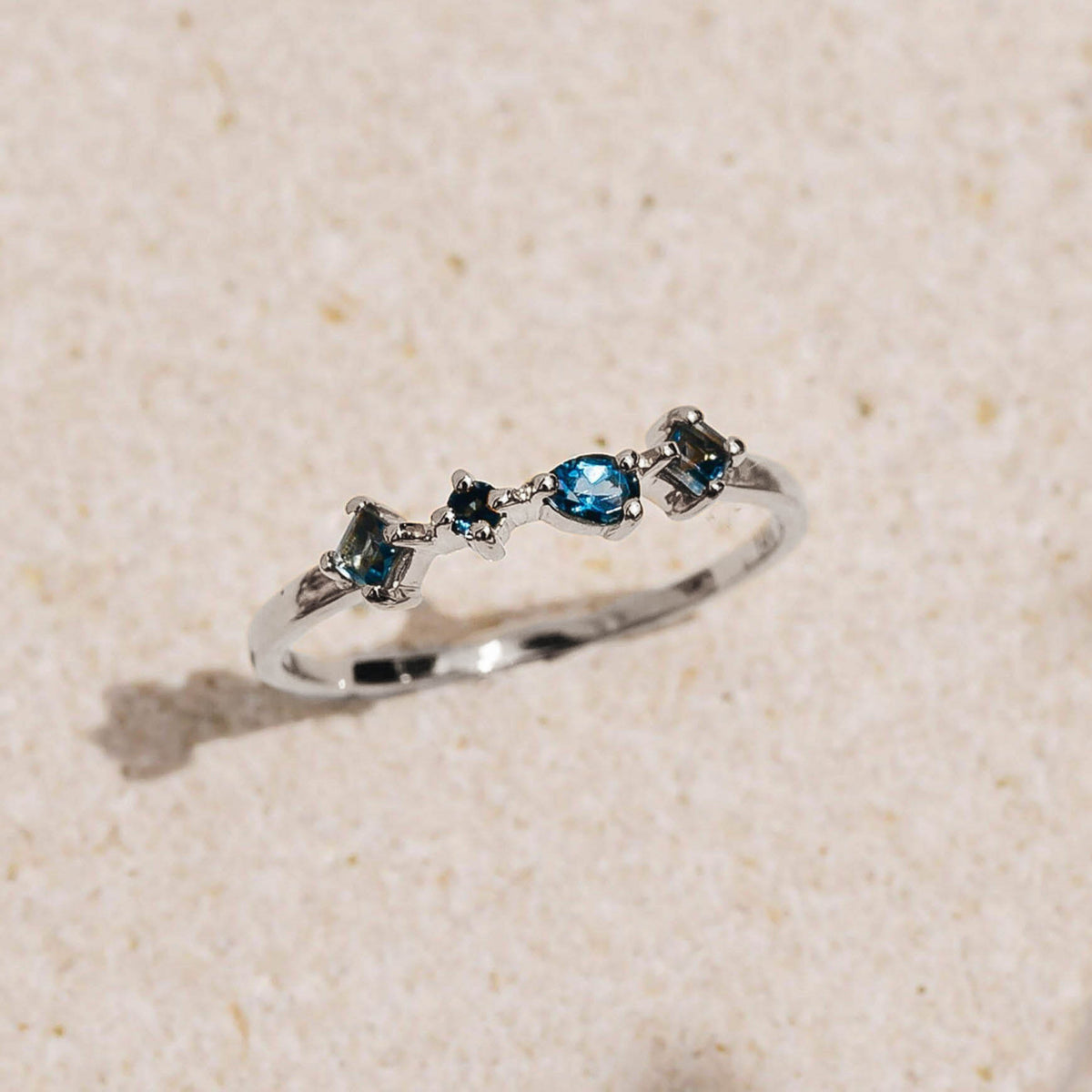 White Gold London Blue Topaz Ring - Ilse Luxe with four unique hand-cut London Blue Topaz stones on white background