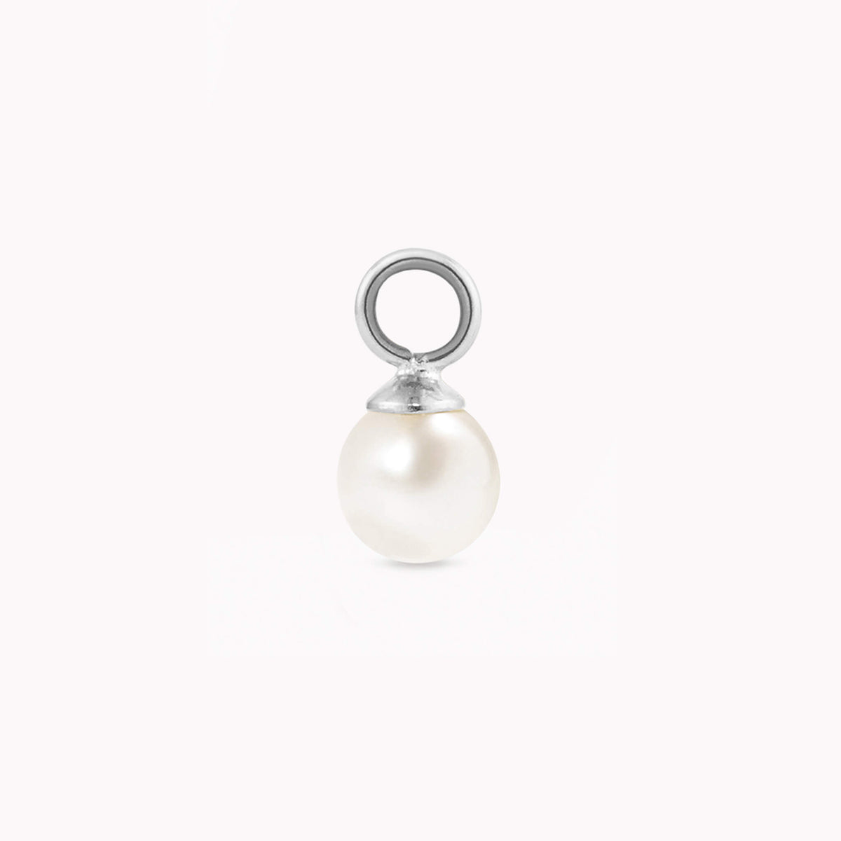 A single, luminous pearl charm with a smooth, white surface and a silver loop for attaching. The pearl exudes elegance against a plain white background.