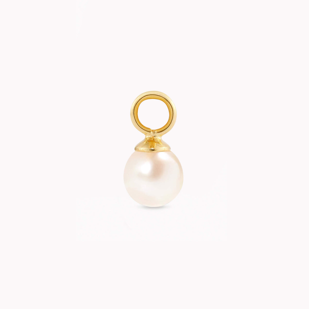 Gold and pearl pendant against a plain white background. The smooth, round pearl hangs from a small, shiny gold loop, conveying elegance and simplicity.