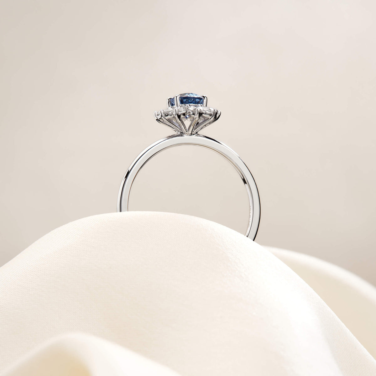 White gold ring with a sapphire gemstone on a white background