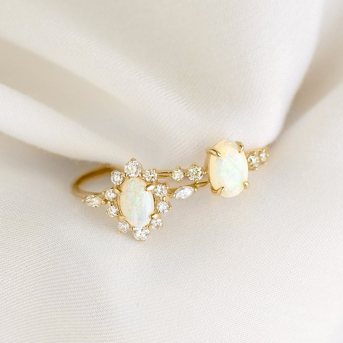 Sunburst Opal Halo Ring - Solana featuring opal cabochons with diamond halos and marquise diamonds on 14k gold band on white fabric