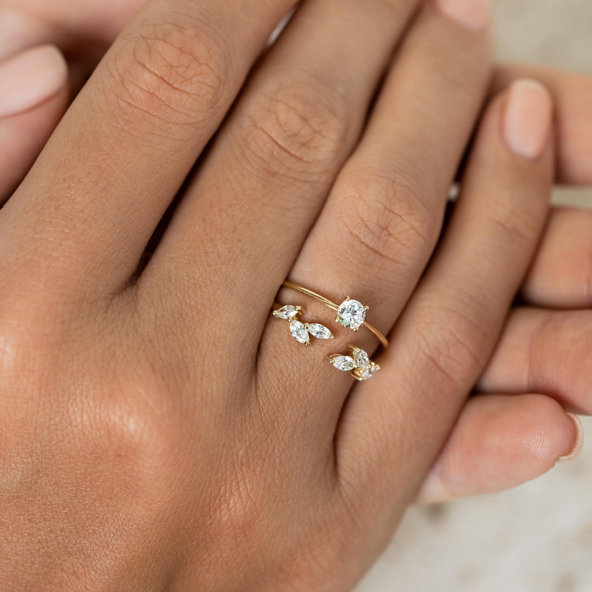 Diamond leaf open ring set with marquise diamonds stacked with diamond ring on yellow gold band
