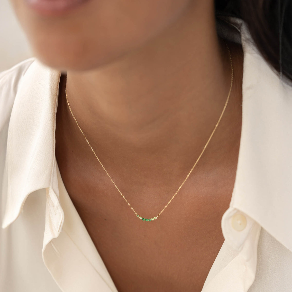 Close-up of August Birthstone Necklace 14k Gold - Ombre Tsavorite with delicate green gemstones on gold chain worn on neck