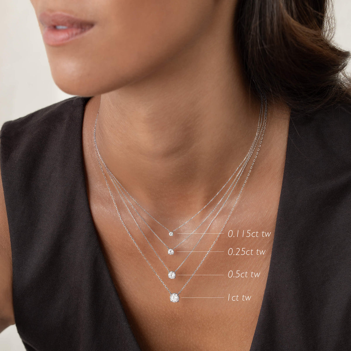Elegant layered White Gold necklaces featuring various diamond weights, showcasing a stylish look for any occasion.