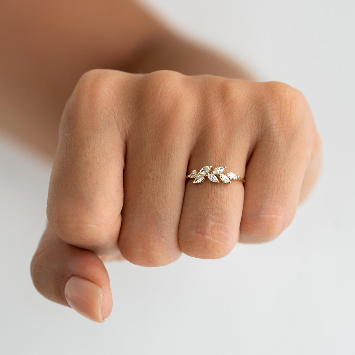 Laurel leaf ring with marquise cut diamonds set on a solid gold band