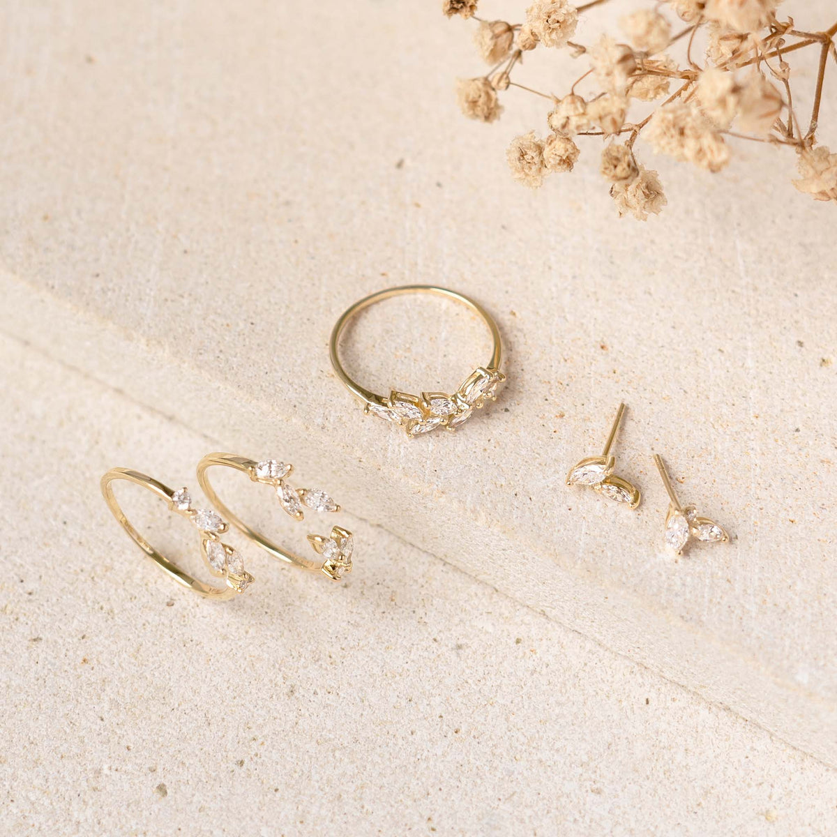 Diamond Leaf Earrings 14k Gold - Selma shown with matching 14k gold rings and hoop earrings on neutral background