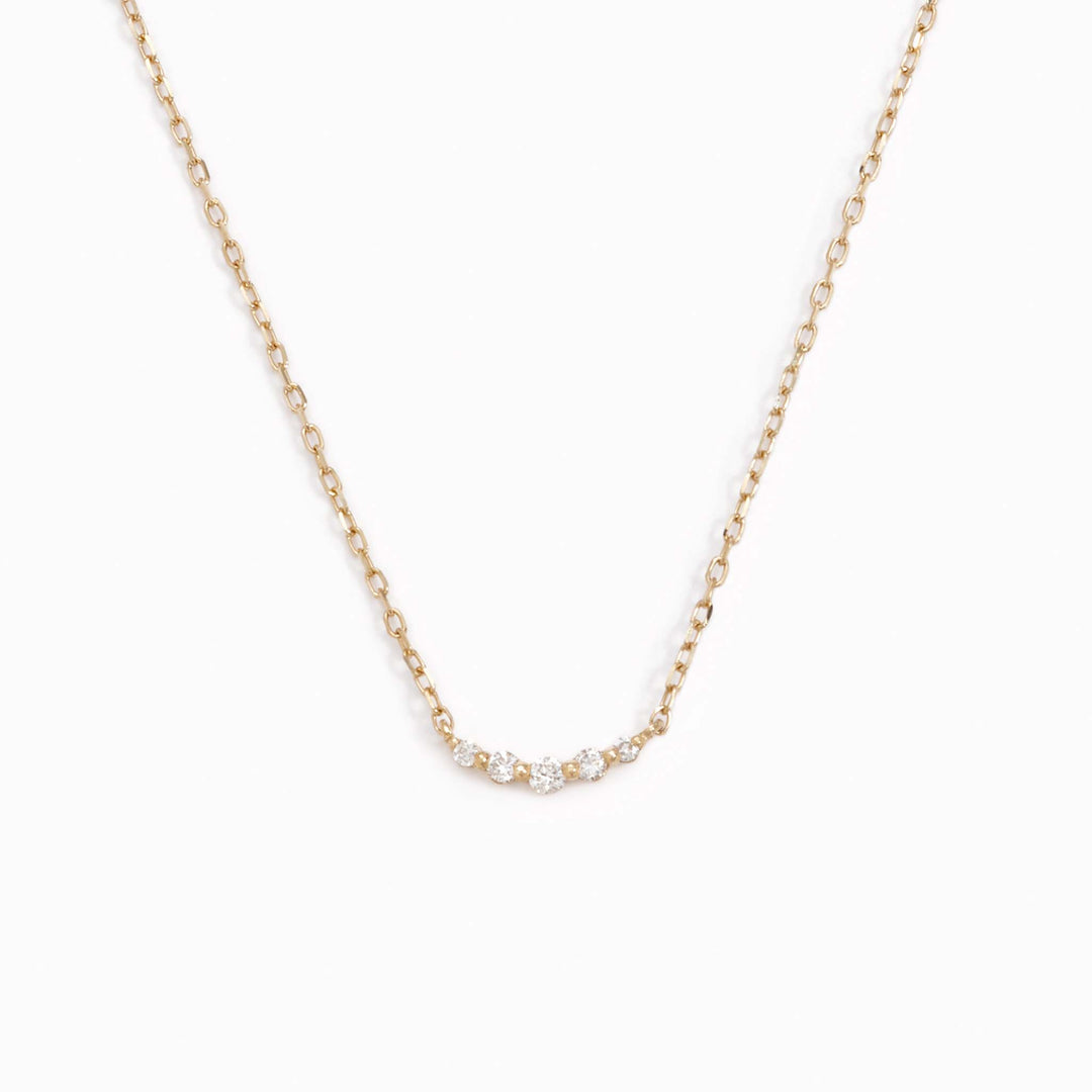 Five lab grown diamonds on a 14k yellow gold necklace chain