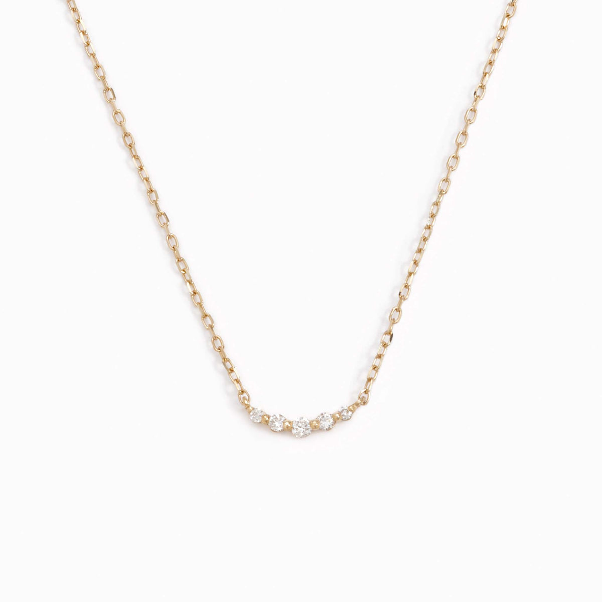 Five lab grown diamonds on a 14k yellow gold necklace chain