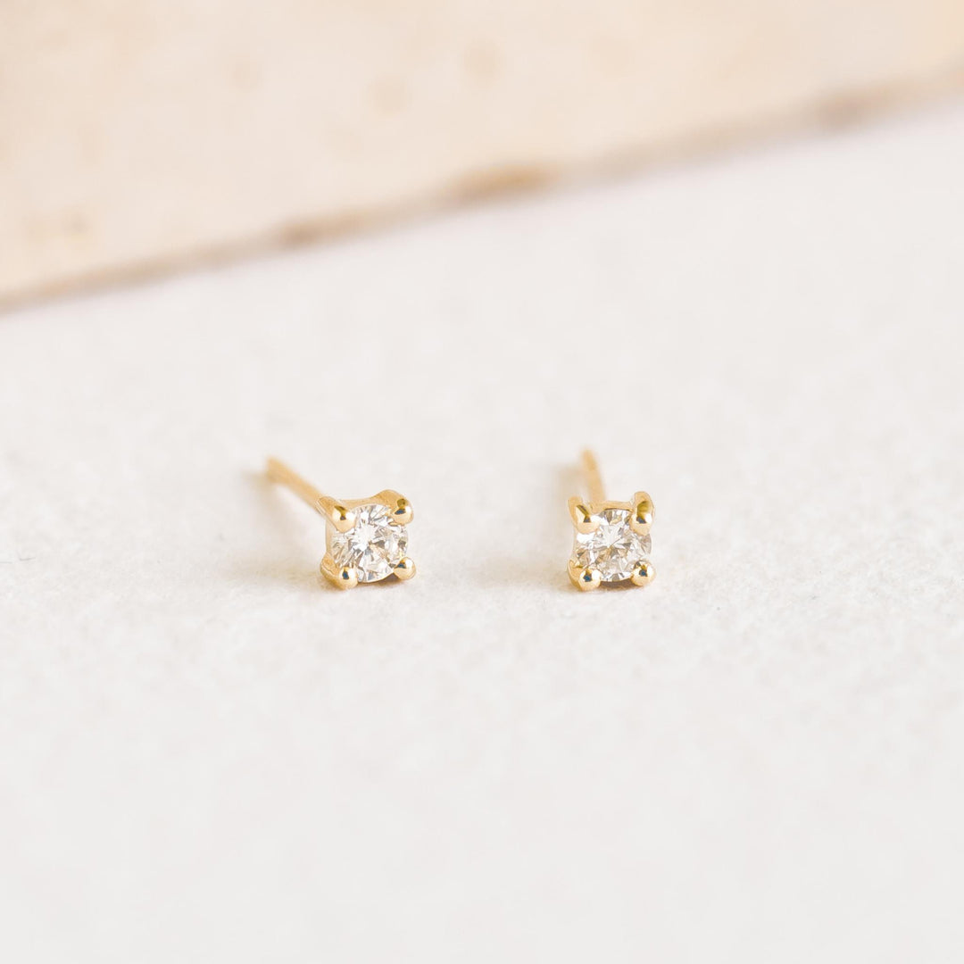 14k Yellow Gold Diamond Stud Earrings 2.5mm - Aria with brilliant lab grown diamonds on a soft neutral background