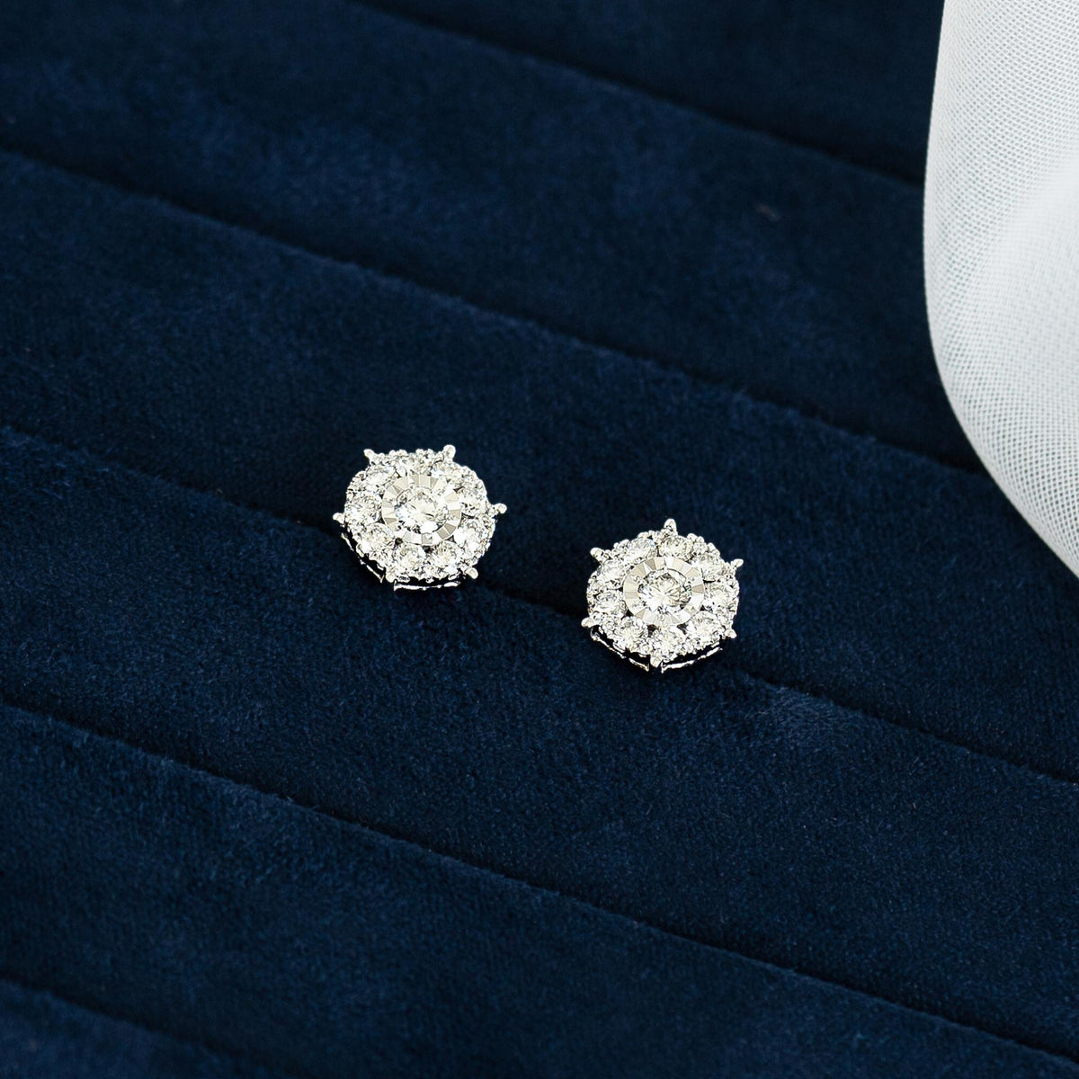Diamond Earrings - 3 Carat Miracle Plate with 38 round-cut diamonds set in 14k white gold on a dark blue background