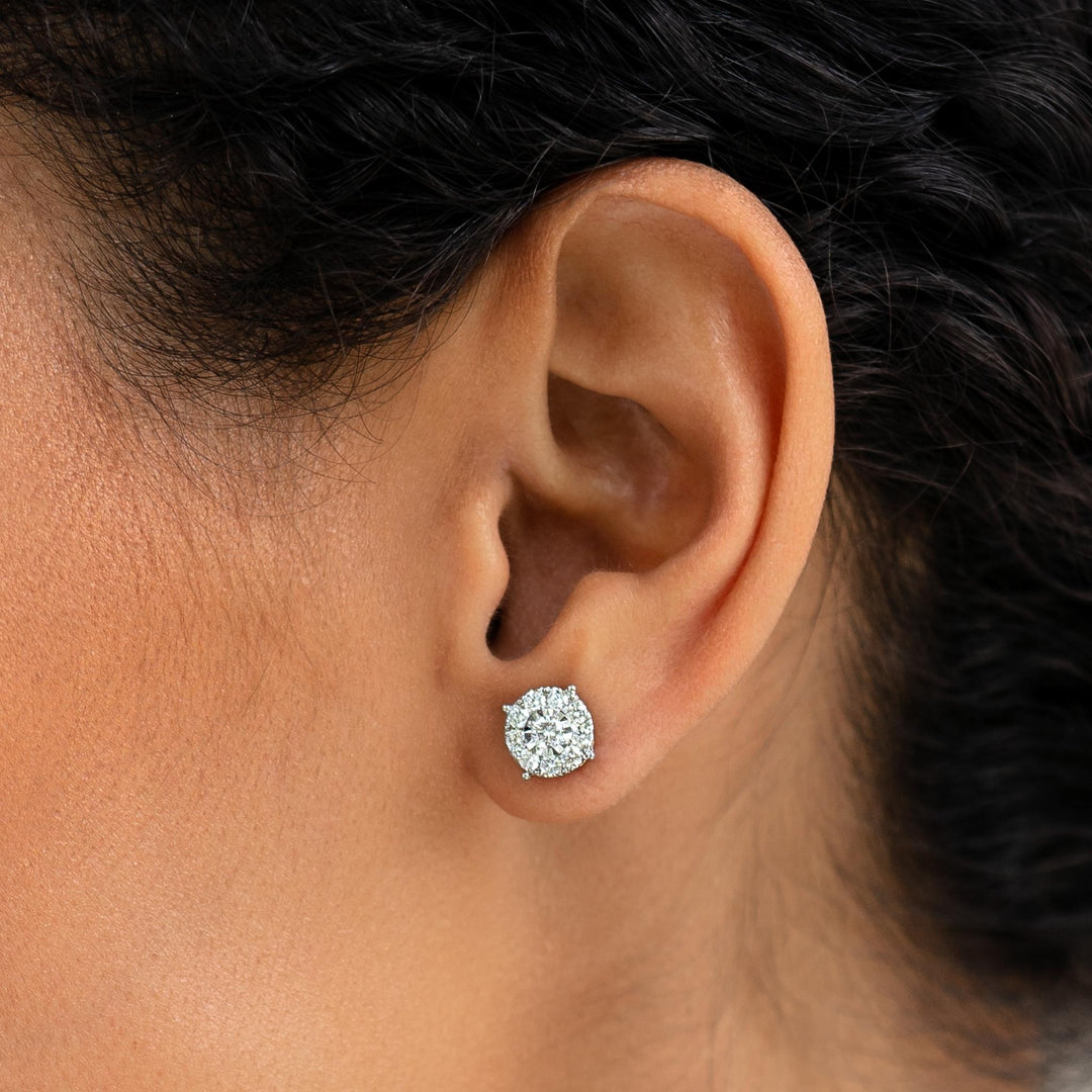 Close-up of a woman wearing Diamond Earrings - 2 Carat Miracle Plate set in 14k white gold on a neutral background