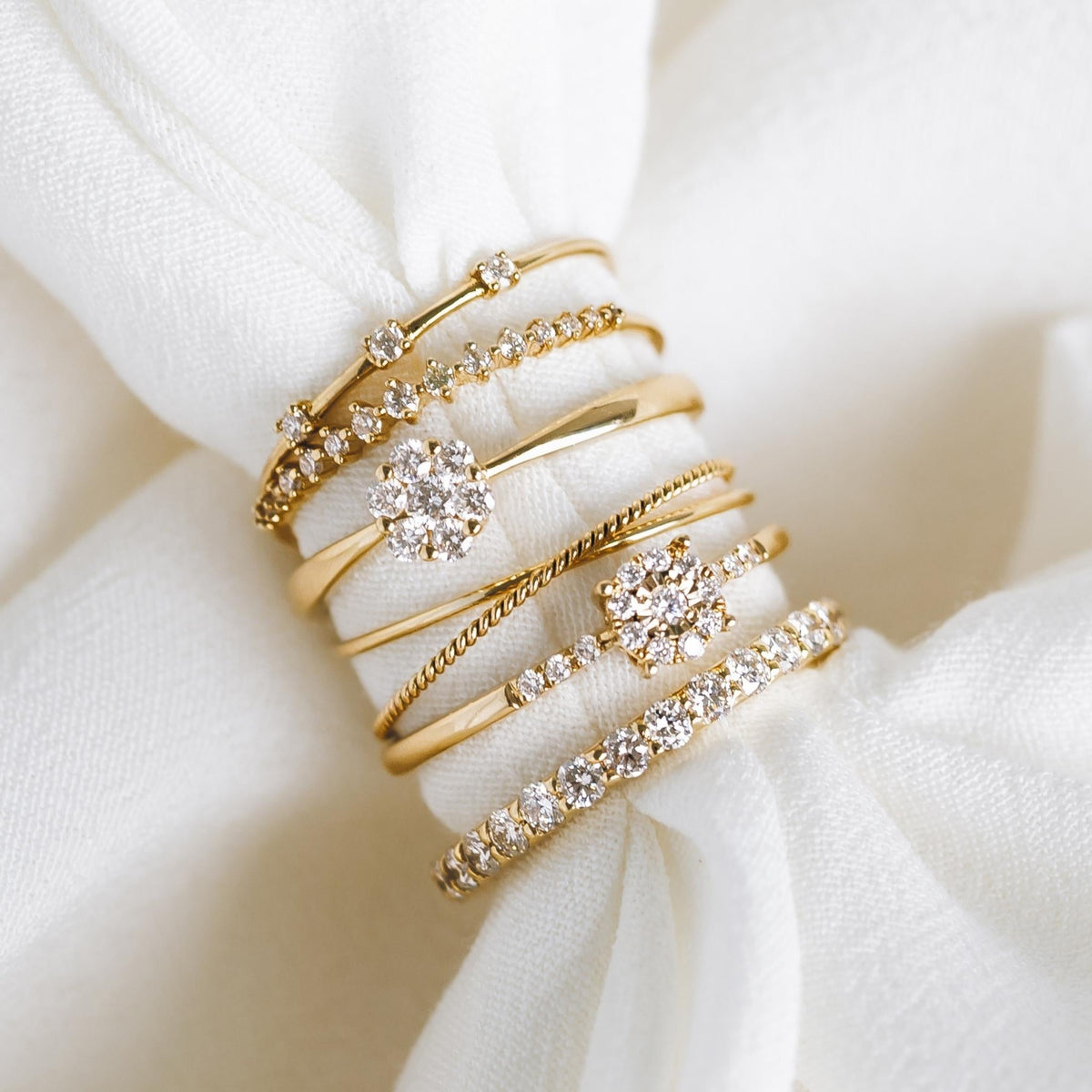 Round Cluster Diamond Ring 14k Gold - Zaira with sparkling diamonds on a 14k gold band displayed on white fabric