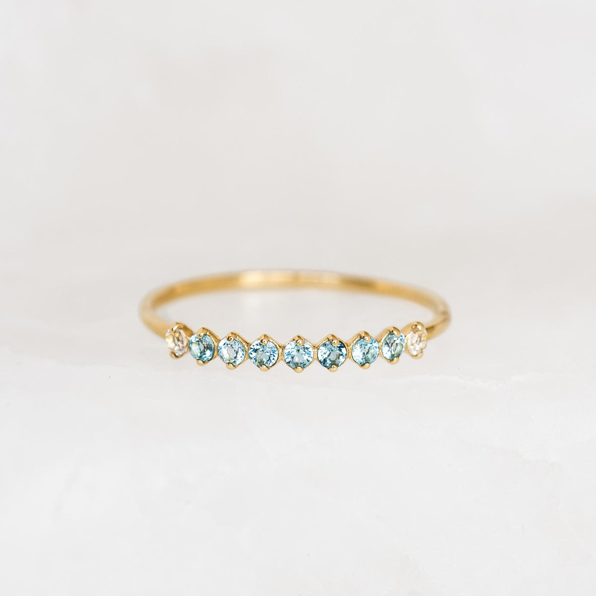September Birthstone Ring 14k Gold - Ombre London Blue Topaz with delicate gemstones set in a thin gold band on white background