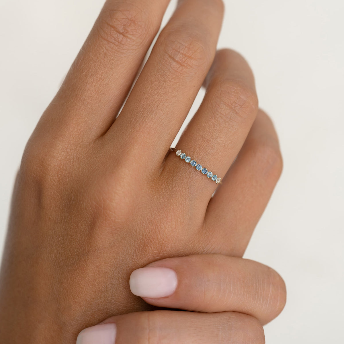 September Birthstone Ring 14k Gold - Ombre London Blue Topaz on a hand against a soft neutral background