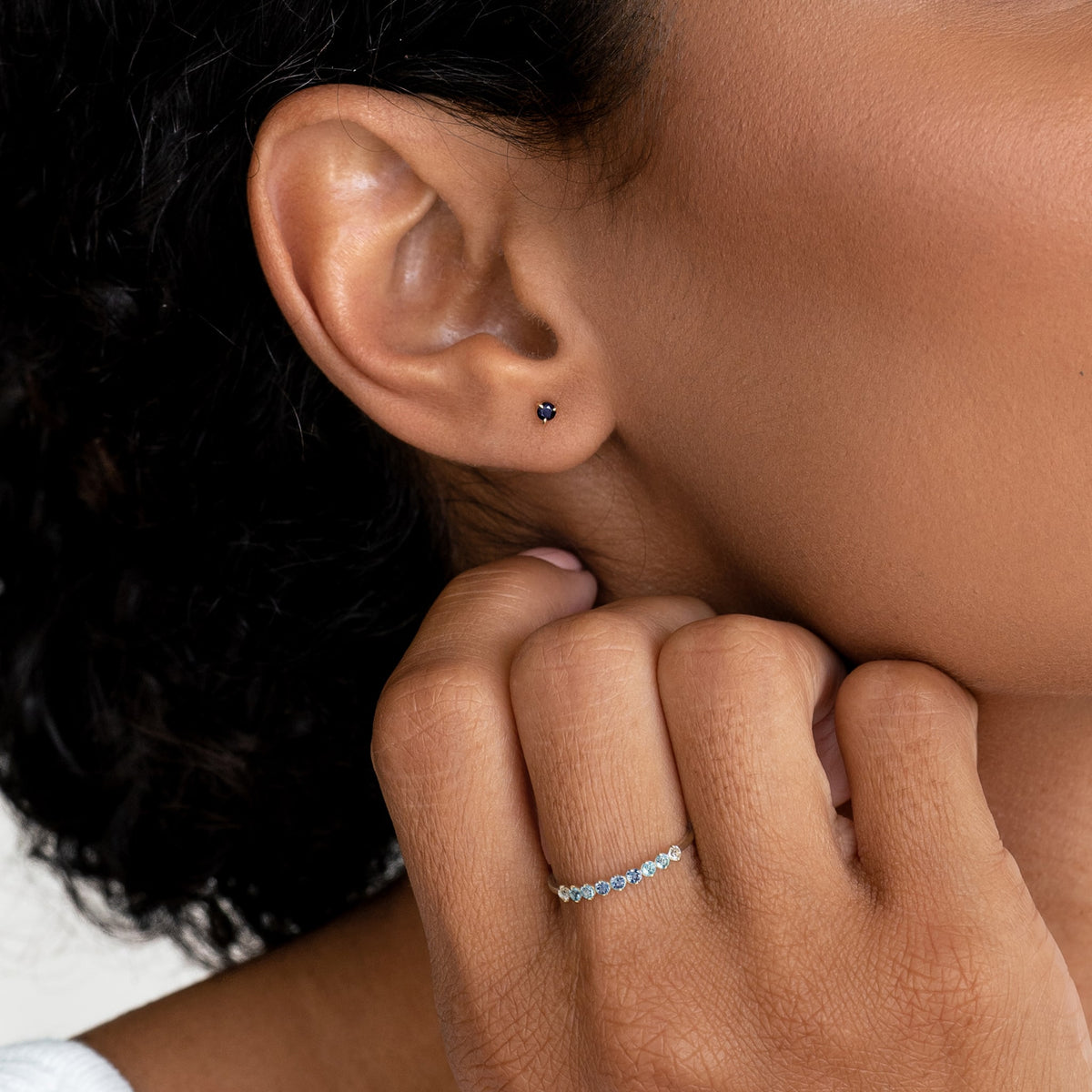 Close-up of a woman wearing the September Birthstone Ring 14k Gold - Ombre London Blue Topaz on her finger