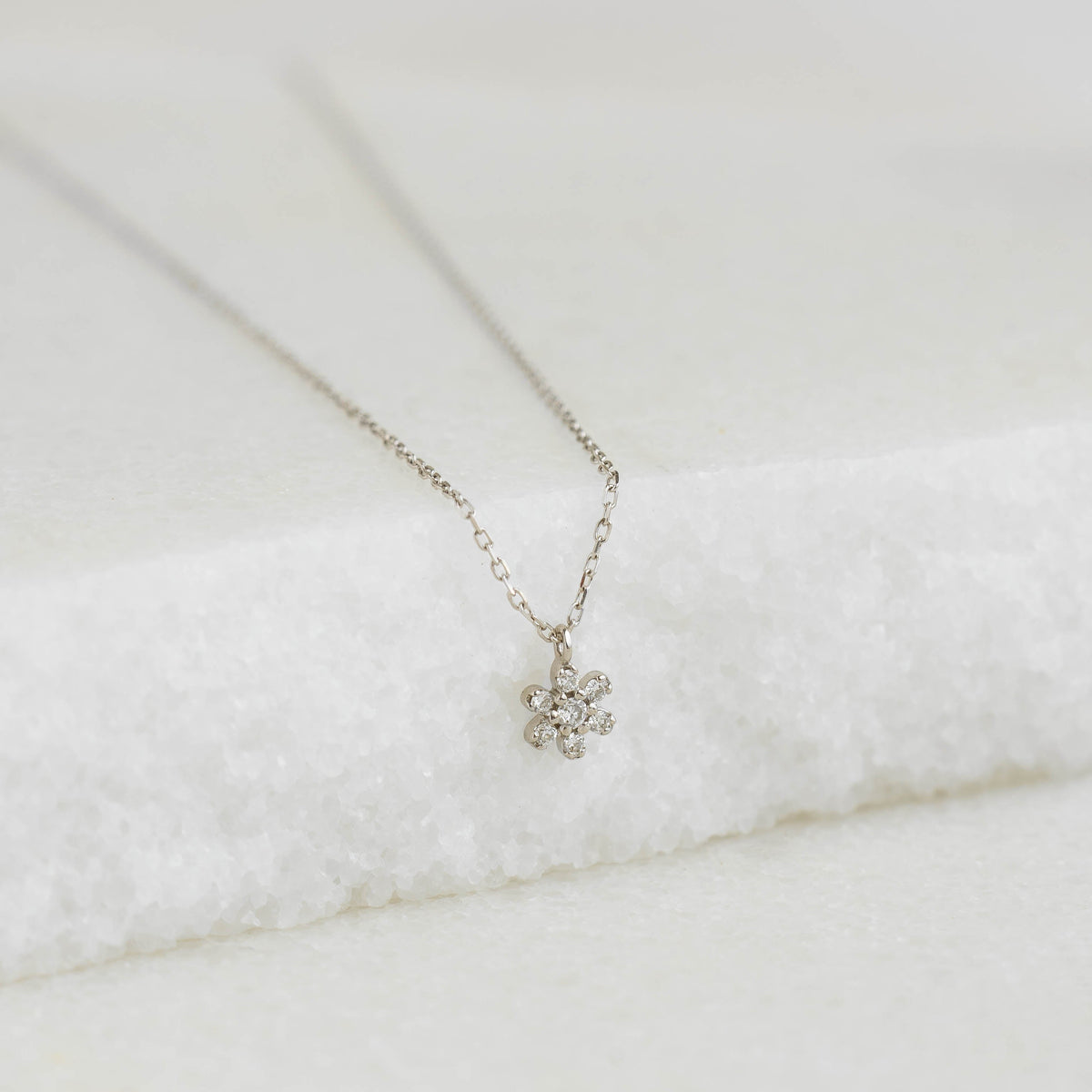 Diamond Flower Necklace White Gold - Haldis featuring a delicate seven-diamond flower pendant on a fine chain