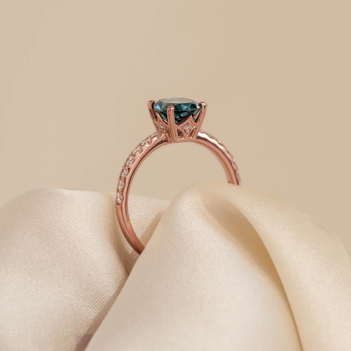 Oval London Blue Topaz and Diamond Ring Rose Gold - Minette with pavé diamonds on a polished rose gold band on beige fabric