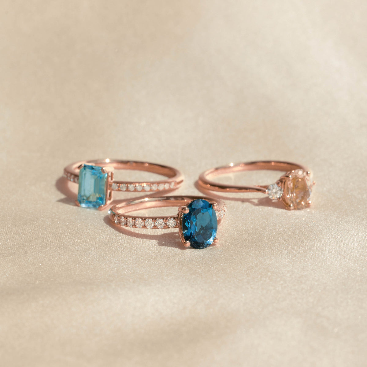 Oval London Blue Topaz and Diamond Ring Rose Gold - Minette with sparkling pavé diamonds on a neutral backdrop
