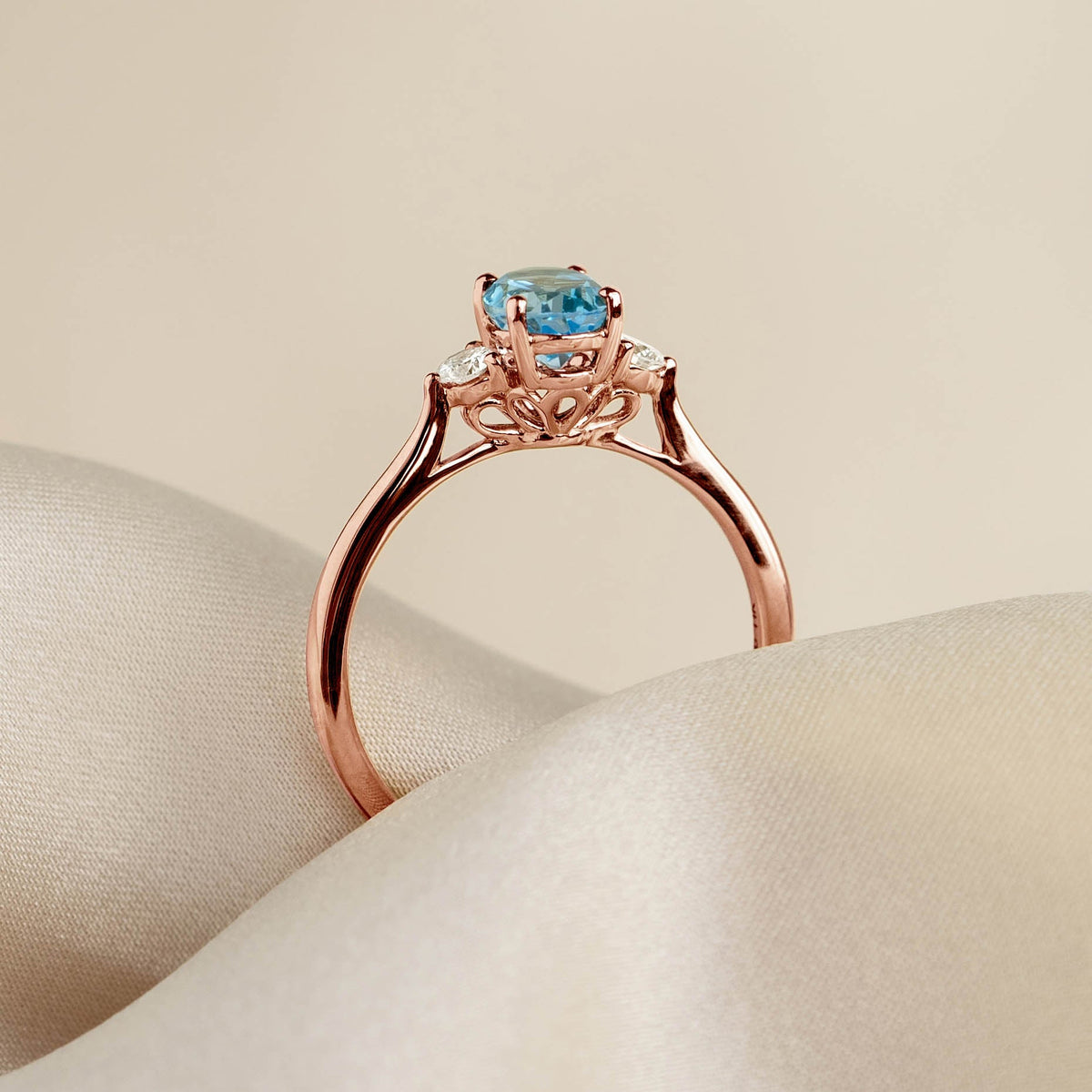 Swiss Blue Topaz and Diamond Ring Rose Gold - Kindra with oval blue topaz and sparkling diamond accents on a smooth band