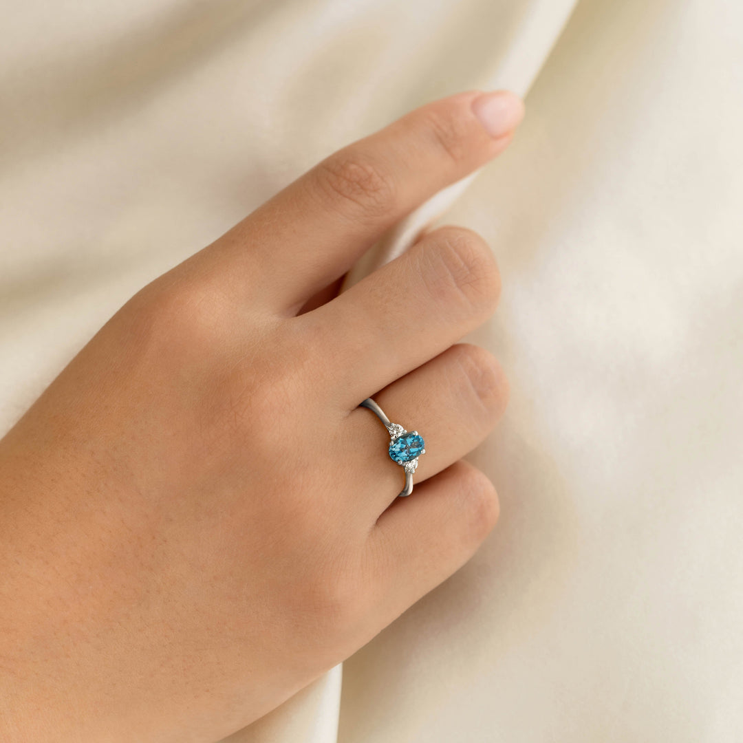 Swiss Blue Topaz and Diamond Ring White Gold - Kindra worn on hand against a soft beige fabric background