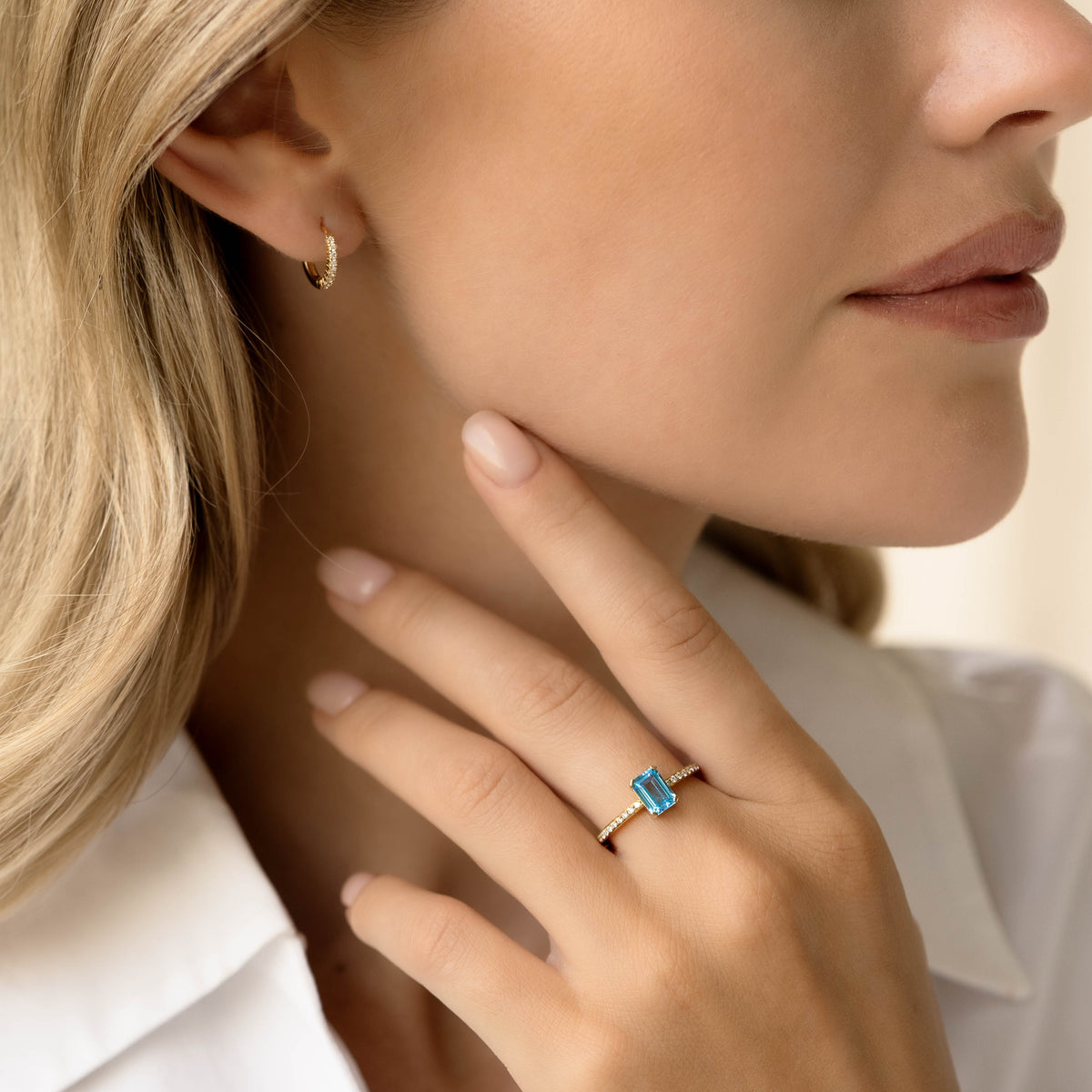 Woman wearing Baguette Swiss Blue Topaz and Diamond Ring 14k Gold - Safiya on her finger against a neutral background