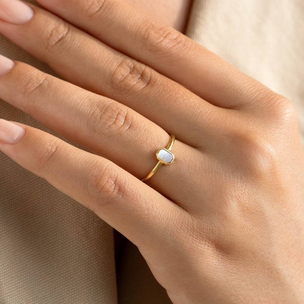 Close-up of hand wearing Mother of Pearl Ring 14k Gold - Maren with delicate pearl inlay on gold band