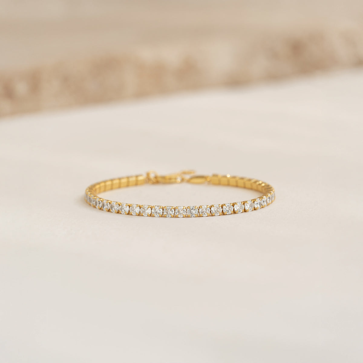 Close-up of Tennis Bracelet - Zilla featuring round cubic zirconia stones set in gold vermeil on a neutral background