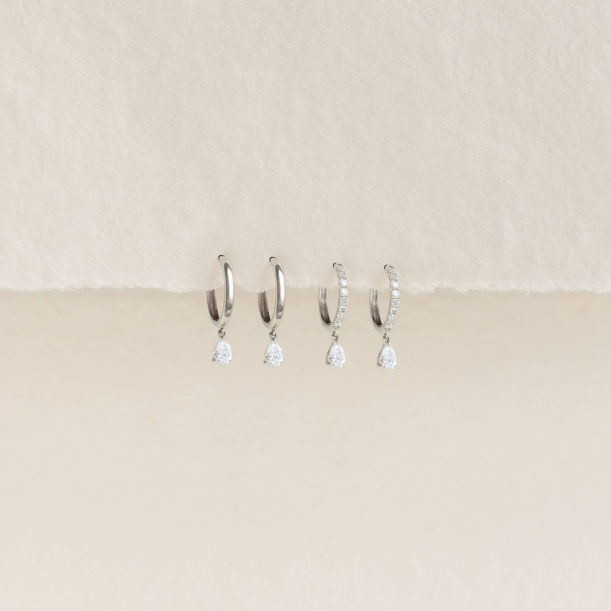 White Gold earrings adorned with pear-cut diamonds, crafted in 14k gold for a luxurious look.