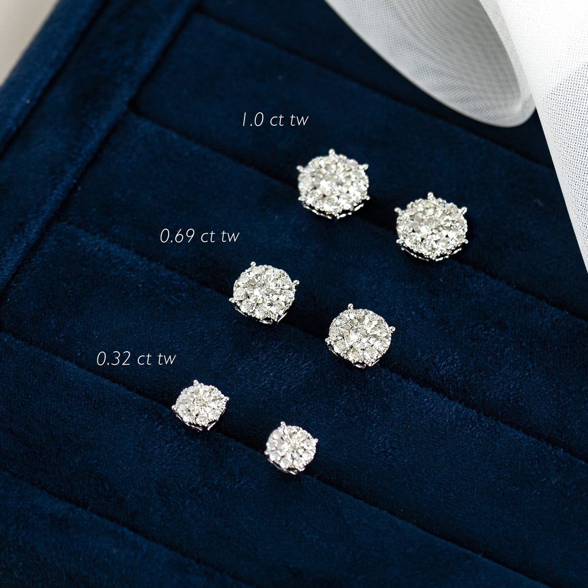 Three pairs of Diamond Earrings - 3 Carat Miracle Plate in 14k white gold displayed on a navy velvet tray