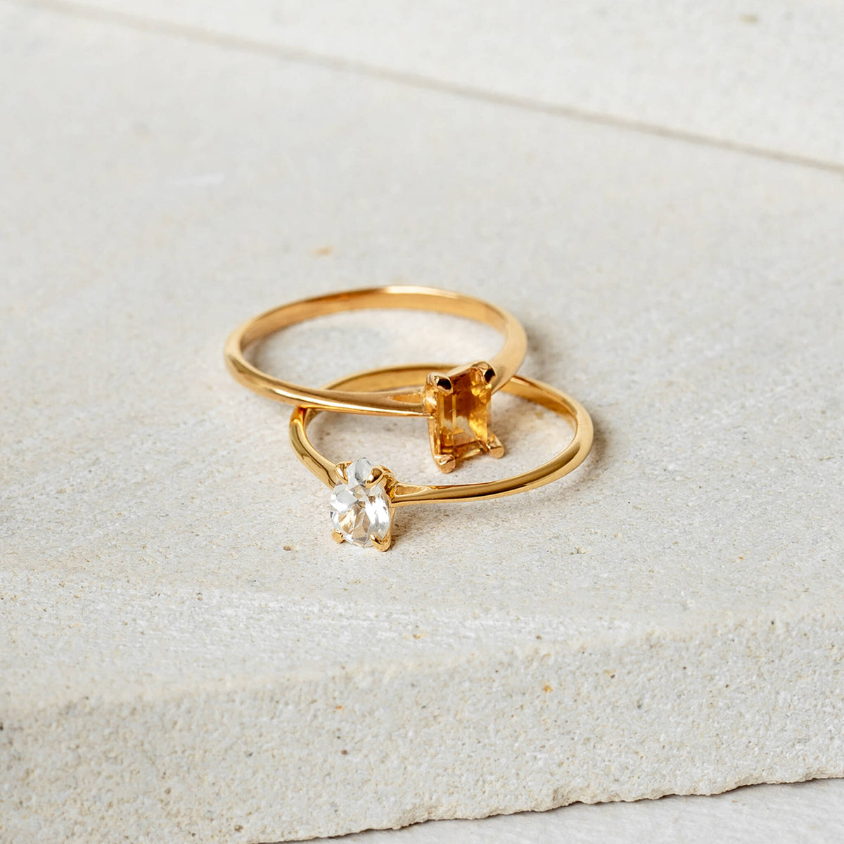 Two gemstone rings in gold with citrine and white topaz