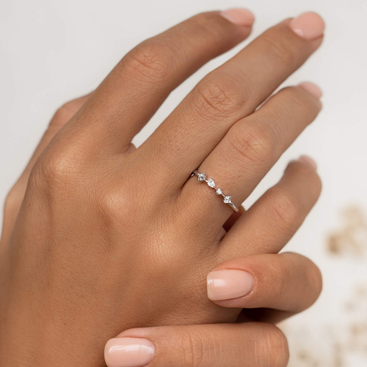 Four lab grown white diamonds on 14k white gold band