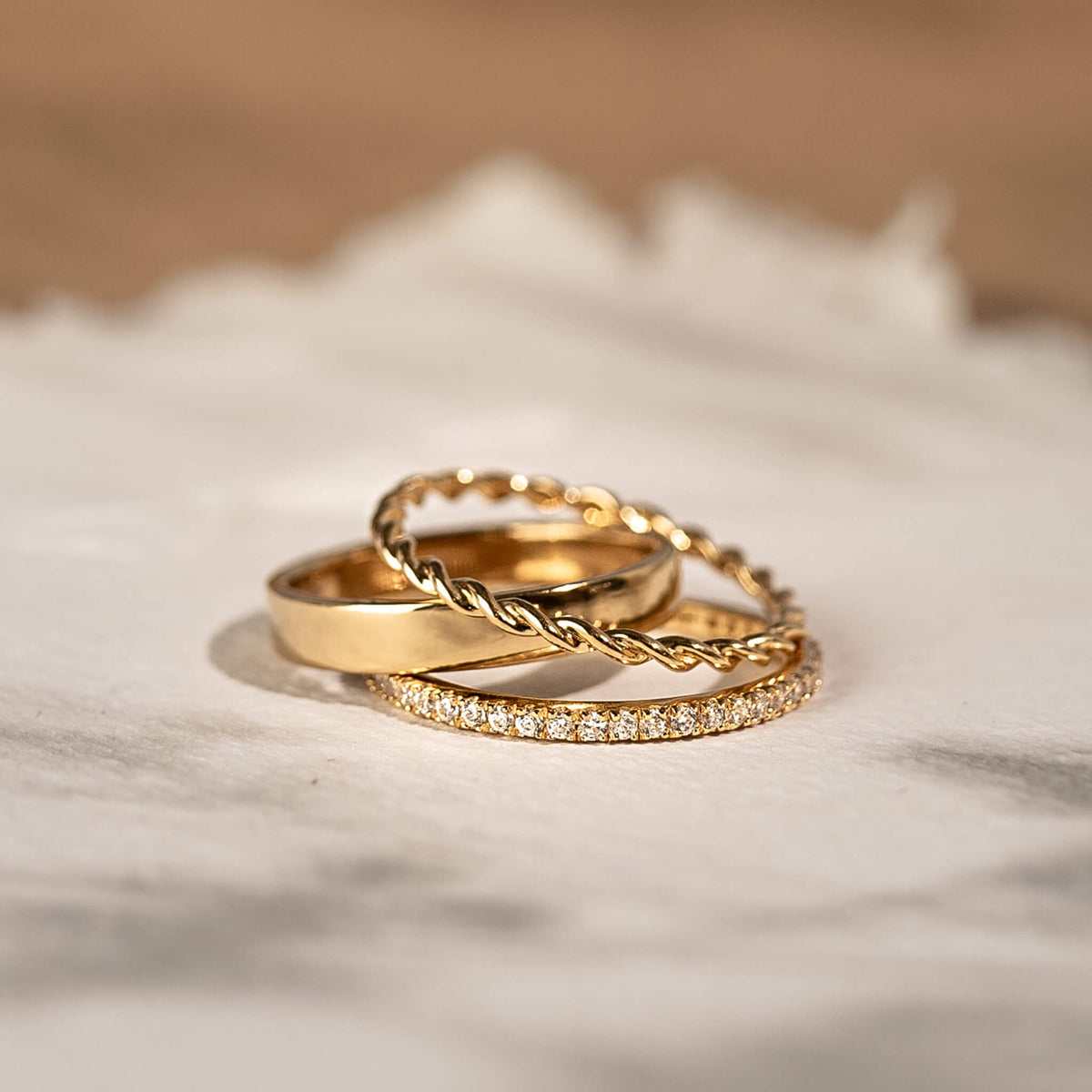 Three gold vermeil stacking rings with twist ring and diamond band