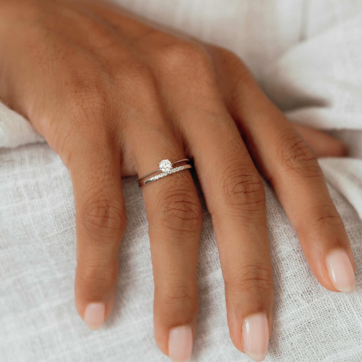 Round diamond ring in white gold 
and pave diamond band on hand
